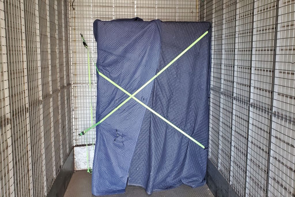 Furniture protected with a removal blanket and secured inside a truck