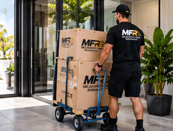 Melbourne Finest Removalists team member moving boxes on a trolley