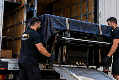 Two Melbourne Finest Removalists team members loading a protected upright piano into a moving truck